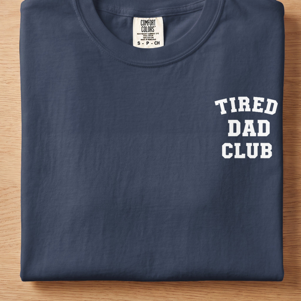 Navy t-shirt with "TIRED DAD CLUB" printed in white on the chest.