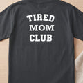 Dark gray t-shirt with white text reading "TIRED MOM CLUB"