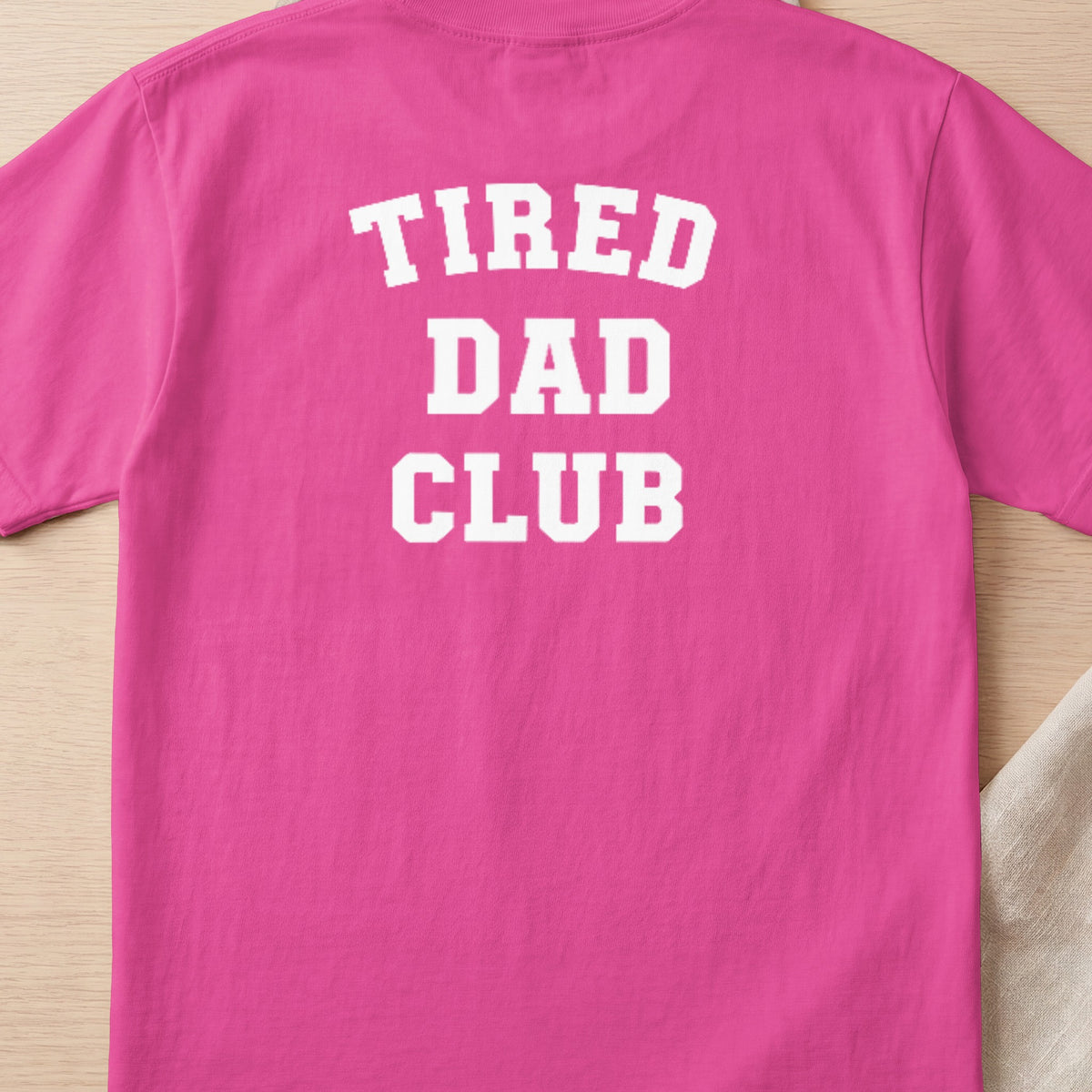Pink t-shirt with white "TIRED DAD CLUB" text on the back.
