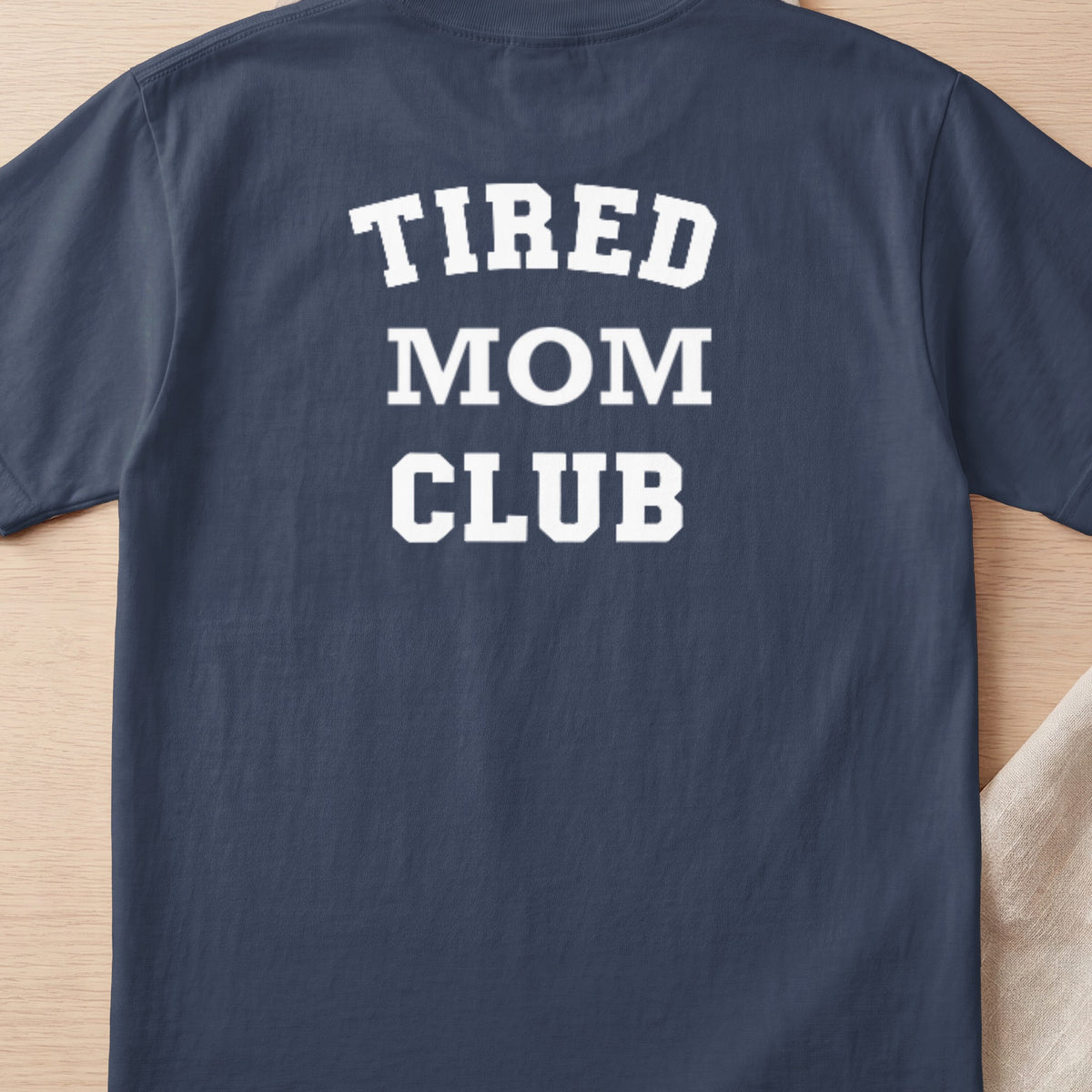 Navy t-shirt with white text reading "TIRED MOM CLUB"