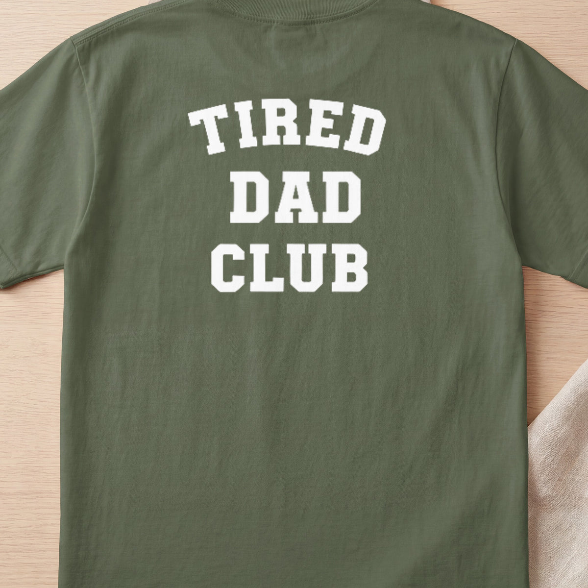 Green t-shirt with white text: "TIRED DAD CLUB"